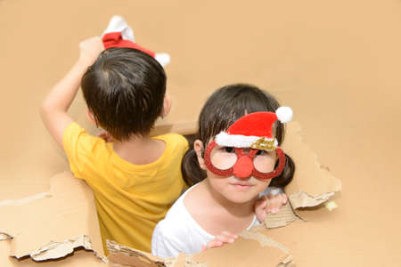 Little girl wearing funny Christmas glasses, having fun while celebrating Christmas day at home