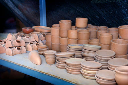Stacks of various terracotta pots for plants. Pottery made on a Potter's wheel by hand.