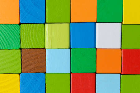Square shape colorful background in red, yellow, green, and blue created of wooden toy blocks