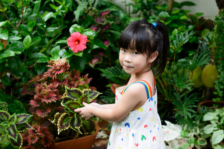 A lovely Asian girl enjoying nature in her backyard.の写真素材