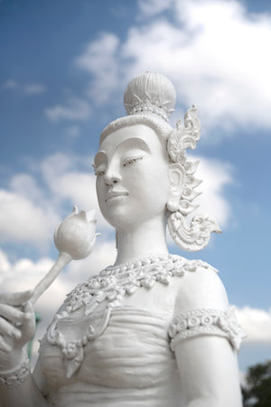 Angel statue against the blue sky background at the temple in Thailand