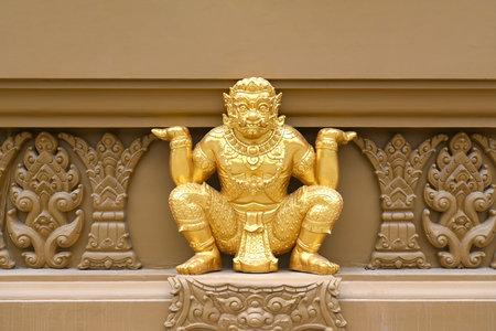 Closeup of decorative Thai art stucco of giants lifting the pagoda base at the temple in Thailandの写真素材