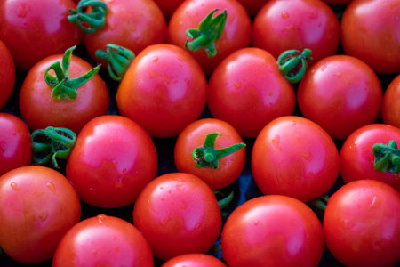 Tomatoes lying on a pile on top of each other, tomato texture. selective focus.の写真素材