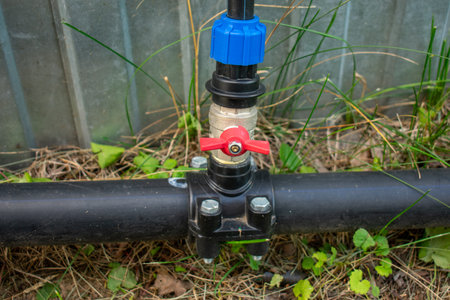 Connection of plastic sewer pipes closeup. Irrigation system for vegetable garden conceptの写真素材