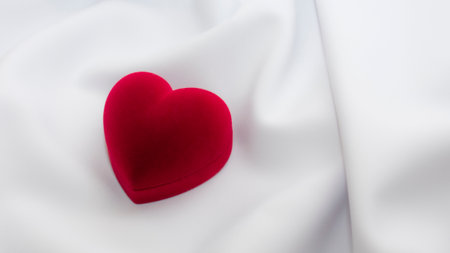 Red velvet heart on a white fabric. Valentine's Day. love concept.の写真素材