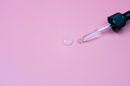 hyaluronic acid in a pipette on a pink backgroundの写真素材