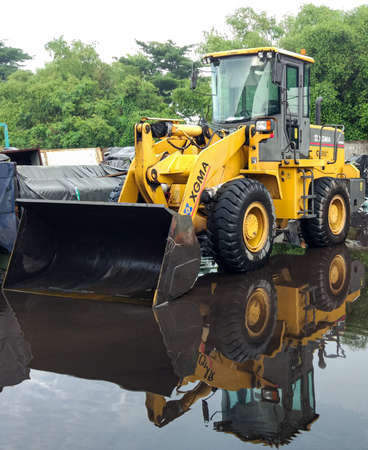 Gresik / indonesia - February - 28 - 2020 : xgma brand loader photos on a puddle of waterのeditorial素材