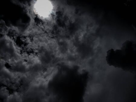 photos of the sun, clouds and black skyの写真素材