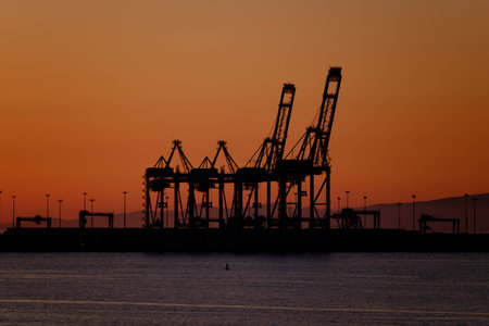 Sun setting over a portの写真素材