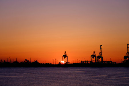 Sun setting over a port