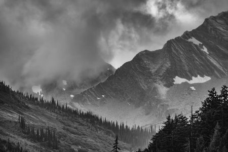 Sun rays hitting mountains in Rogers Pass, BCの写真素材