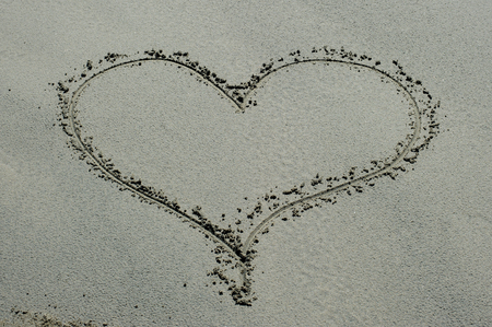 Heart drawn in the sandの写真素材