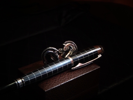 precious pen and cuff link in dark の写真素材