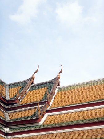 gable apex decorated by pieces of color grass crafte on the roof of Thai temple           の写真素材
