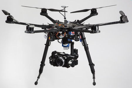 A hexacopter with attached camera isolated on a white background