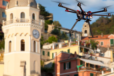 A flying drone without a camera with a blured old town in the backgroundの写真素材
