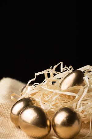 gold Easter eggs on a black backgroundの写真素材
