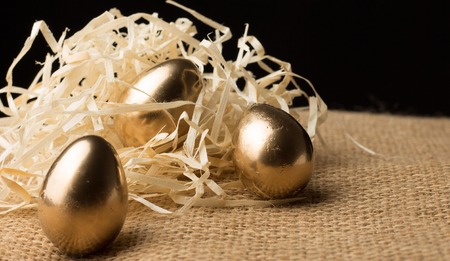 gold Easter eggs on a black backgroundの写真素材