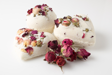 Bomb salt bath decorated with dried roses on a white backgroundの写真素材