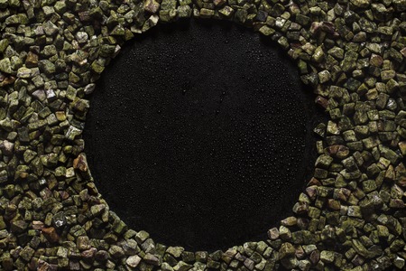 frame with natural stone on a blackの写真素材