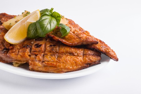 Grilled mackerel with lemon on a whiteの写真素材