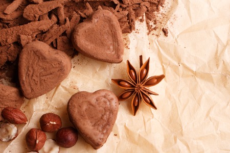 Chocolate heart-shaped candy on a rustic background