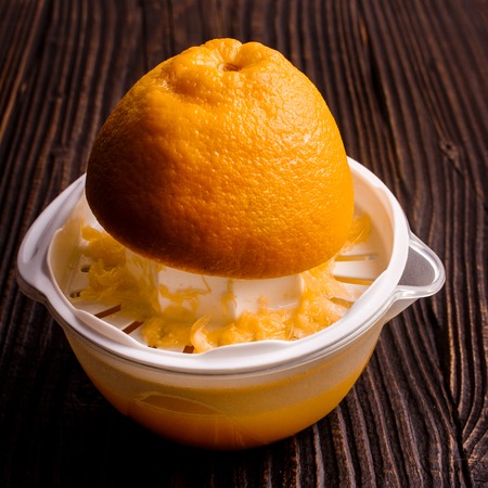 oranges and juice on a wooden background.