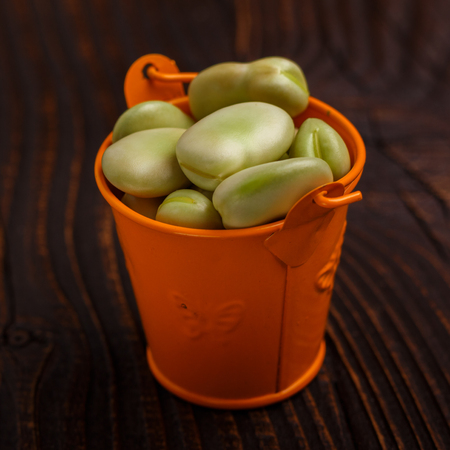 fresh broad beans on a rustic background.の写真素材