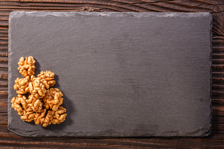 Walnut on a dark rustic wooden background.の写真素材
