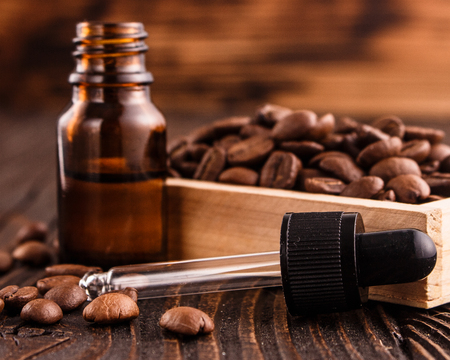 essential oil of coffee beans on a wooden background.の写真素材