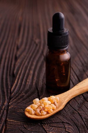 frankincense essential oil on a wooden background.の写真素材