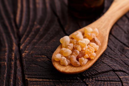frankincense essential oil on a wooden background.の写真素材