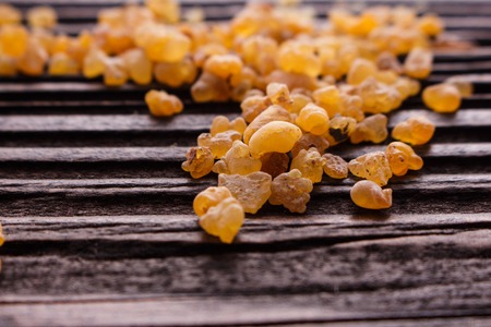 frankincense essential oil on a wooden background.の写真素材