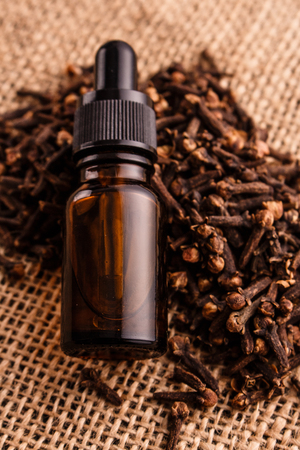 essential oil of cloves on a wooden rustic background.の写真素材