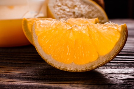 oranges and juice on a wooden background.の写真素材