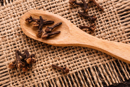 essential oil of cloves on a wooden rustic background.の写真素材