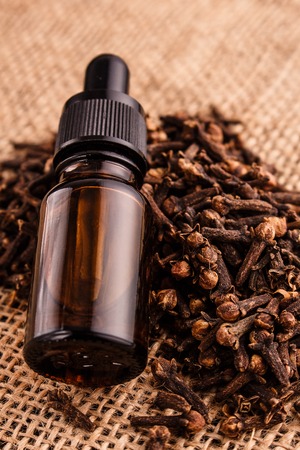 essential oil of cloves on a wooden rustic background.の写真素材