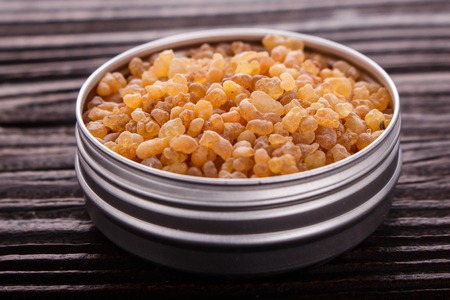 frankincense essential oil on a wooden background.の写真素材