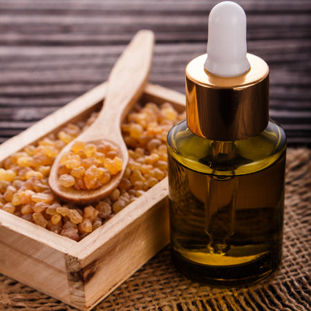 frankincense essential oil on a wooden background.の写真素材