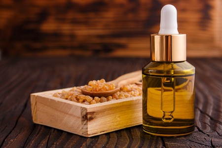 frankincense essential oil on a wooden background.の写真素材