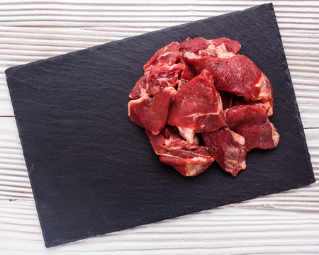 fresh lamb meat on a textured stone plate.の写真素材