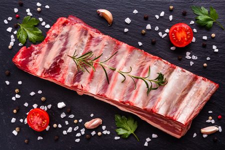 fresh lamb meat on a textured stone plate.の写真素材