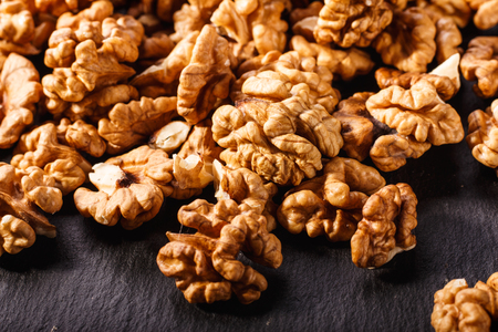 Walnut on a dark rustic wooden background.