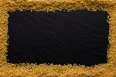 a bunch of millet on a dark rocky background.の写真素材