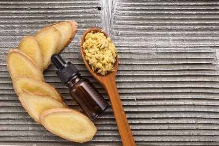 Ginger root essential oil on a dark background.の写真素材