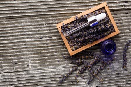 Lavender essential oil on a wooden background.の写真素材
