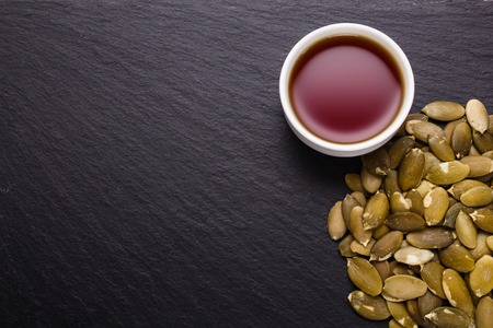 pumpkin seed oil on a rustic background.