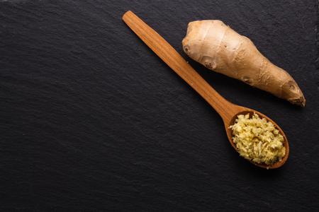 Ginger root on a dark stone background.の写真素材