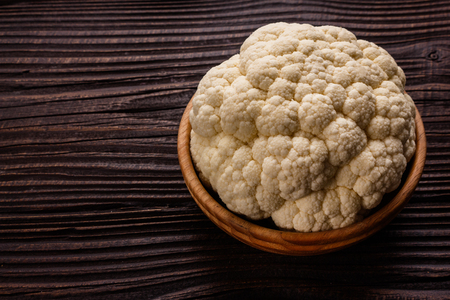fresh cauliflower on a rustic wooden background.の写真素材