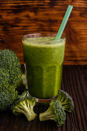 fresh broccoli juice on a wooden background.の写真素材